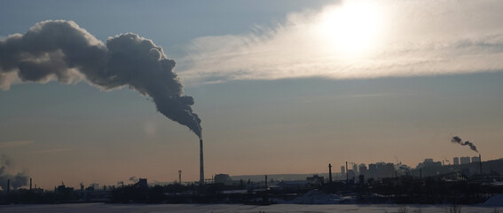 Pipes smoke among the city blocks