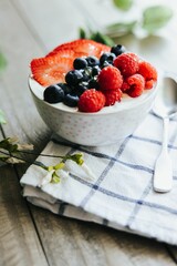 Vertical High angle closeup of a dessert bowl with Strawberries Blueberries and Raspberries