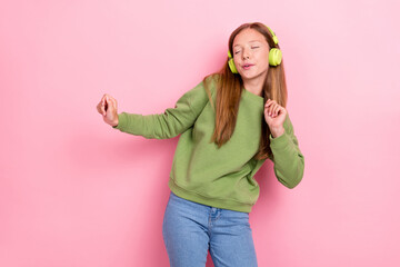Photo of charming pretty school girl dressed green sweatshirt headphones enjoying music dancing...