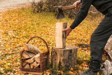 A man is chopping wood with an axe.