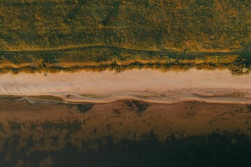 Aerial shot of a beach surrounded by the sea for wallpapers
