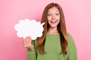 Photo of impressed funky school girl dressed green sweatshirt holding speaking bubble empty space isolated pink color background