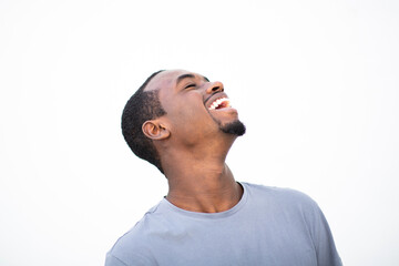 Fototapeta premium Cheerful young african american man laughing against white background