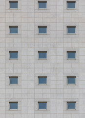 Fototapeta na wymiar Building's facade. Reflection of the sky in the windows