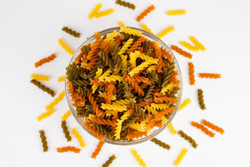Top view of Italian tricolor fusilli paste in glass bowl isolated on white background. Close-up....