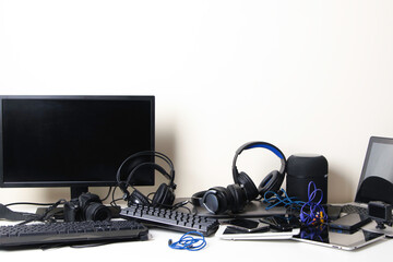 Old computers, digital tablets, mobile phones, headphones, many used electronic gadgets devices on...
