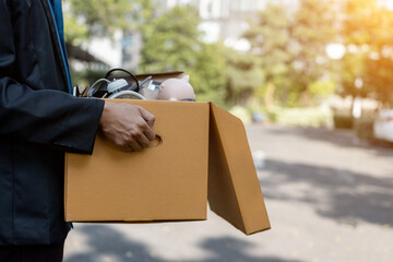 Unemployed man carrying business cardboard box. unemployment, fired from job, quitting job concept.