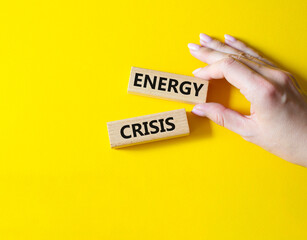 Energy crisis symbol. Concept word Energy crisis on wooden blocks. Businessman hand. Beautiful yellow background. Business and Energy crisis concept. Copy space