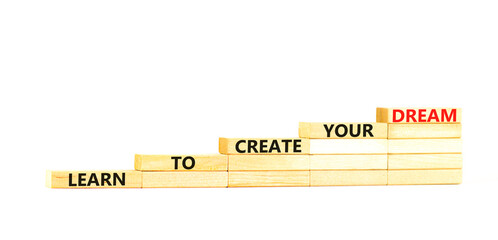 Create your dream symbol. Concept words Learn to create your dream on wooden blocks. Beautiful white table white background. Business learn to create your dream concept. Copy space.