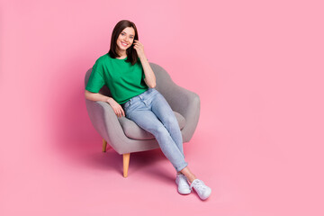 Full body photo of satisfied glad lady sitting chair hand touch hair isolated on pink color...