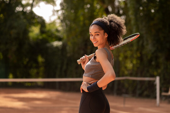 Cute african american girl with tennis racket