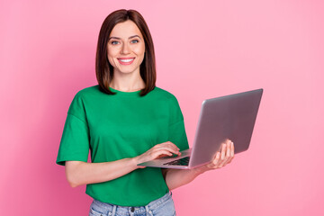 Photo of pretty positive lady hold wireless netbook toothy smile isolated on pink color background