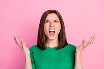 Photo of young funny unhappy woman agressive look up screaming small salary isolated on pink color background