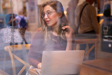 Woman using tablet computer in cafe