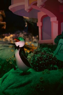 Colorful Disney's figure of a penguin, in Melbourne, Australia, displayed under the green light