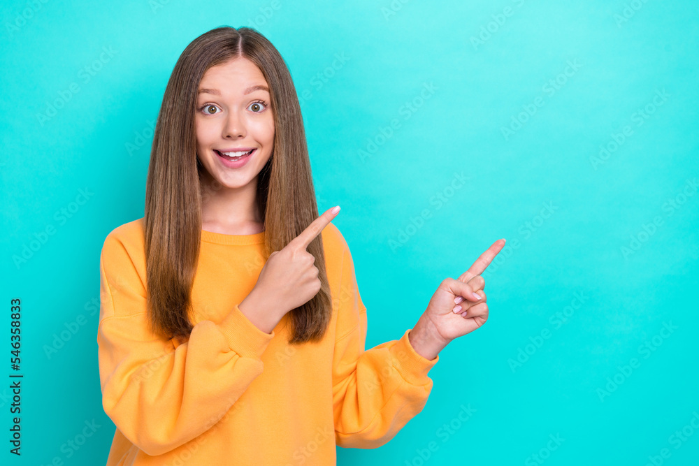 Sticker Photo of young funny excited youngster girl brown hair orange pullover fingers direct mockup unexpected black friday sale isolated on cyan color background