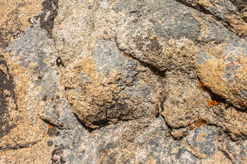 texture of a rock stone break with gray, black, brown and orange hues