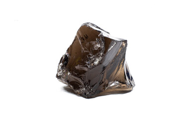 Raw shiny semi-transparent uncut real black obsidian volcanic glass crystal isolated on a white background surface focused macro