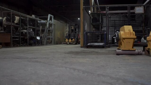 The forklift with products at the warehouse, forklifts traveling between the rows in the warehouse. Clip. Industrial interior.