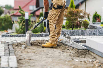 Contractor Laying a Brick Paving Path