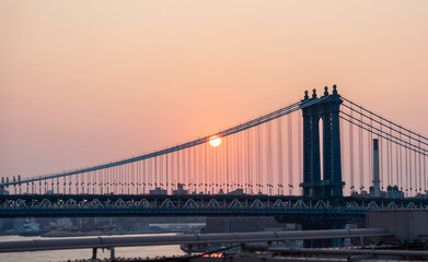 Manhattan Bridge at dawn and some disc of the rising sun