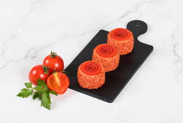 Tomato mousse cottage cheese cream appetizer of round cylindrical shape with tourbillon jelly, on a serving board. White background	