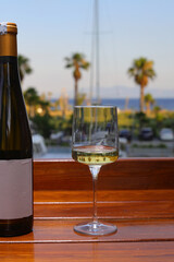 glass of white wine on the beach	