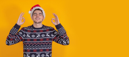 isolated young man with santa claus hat celebrating christmas