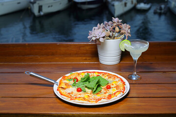 assorted pizza with different fillings: salami, tomatoes, mushrooms, bacon, sun-dried tomatoes. Horizontal frame