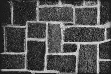 Several rows of a rough textured concrete block wall as background, wallpaper.  Old-style brick and interbed concrete mortar