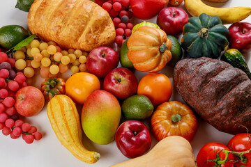 Table is filled with variety of fruits and vegetables.