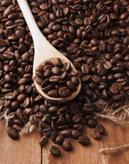 Fresh coffee beans and wooden spoon with copy space