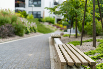 Wooden bench in recreation area near modern office building