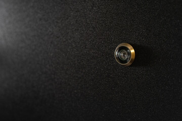 Peephole lens on new metal door in apartment