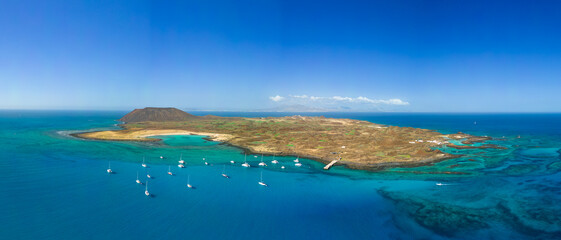 Low level panoramic aerial image of Lobos island and sheltered bay looking very tropical in the sunshine, near Corralejo Fuerteventura
