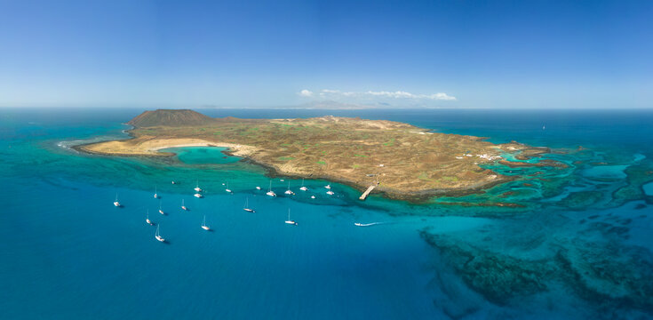 Mid level panoramic aerial image of Lobos island and sheltered bay looking very tropical in the sunshine, near Corralejo Fuerteventura