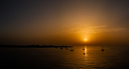 Stunning low level aerial image of the yachts, boats, moored off the island of Lobos at sunrise near Corralejo Fuerteventura