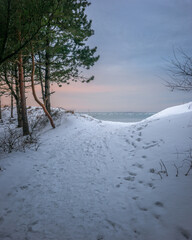 Snow covered winter beach on the sea