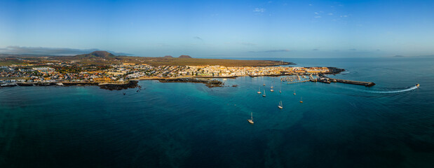 Mid level aerial panoramic view of Corralejo harbour, town and beaches, Fuerteventura