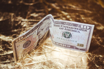 American dollars on a golden background, money and finance