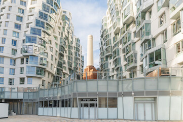 Fototapeta premium One of four chimneys of iconic London landmark Battersea Power Station and surrounding area with appartments and offices.
