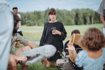 Director at work on the set. The director works with a group or with a playback while filming a...