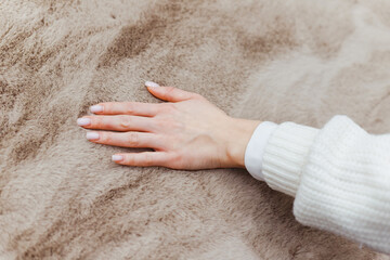 Close up of hand touching soft carpet. Gentle and fluffy carpet between fingers.