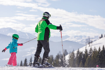 children skiing and snowboarding in the mountains, ski resort