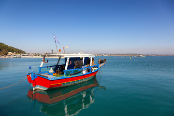Small Fishing Boat in a touristic town by Ionian Sea. Katakolo, Greece. Sunny Sky.