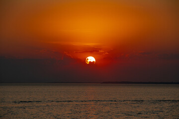 Amazing Black sea sunset. Clouds, water, orange landscape background. Drama juicy sky and red sun....