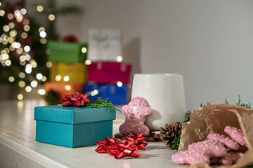 Beautiful blue gift box  on wooden table against blurred festive lights