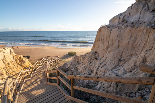 One of the most beautiful beaches in Spain, called (Cuesta Maneli, Huelva) in Spain.  Surrounded by dunes, vegetation and cliffs.  A gorgeous beach.