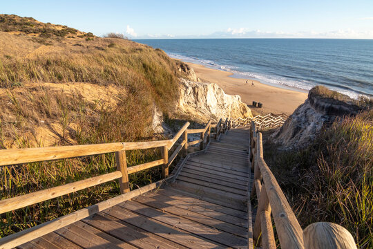 One of the most beautiful beaches in Spain, called (Cuesta Maneli, Huelva) in Spain.  Surrounded by dunes, vegetation and cliffs.  A gorgeous beach.