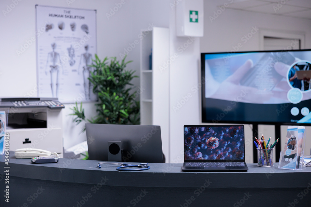 Poster laptop screen on empty front desk showing sample of coronavirus cell. laboratory images taken with m